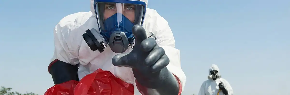 sewage clean up technician wearing protective gear handling biohazard materials in Richmond, VA
