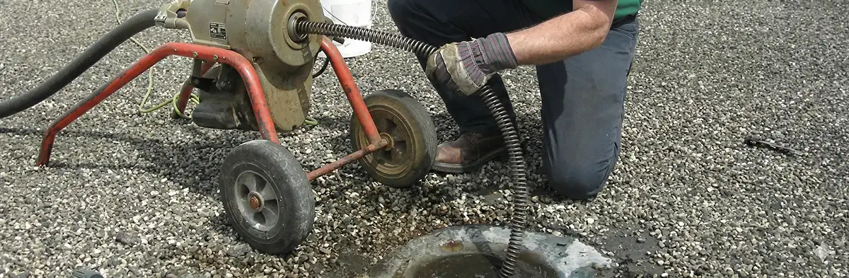sewer rodding technician actively removing blockages from a sewer line in Richmond, VA